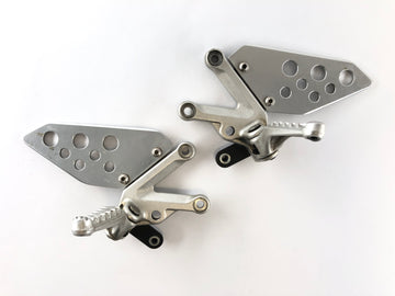 Aprilia RSV 1000 RR Factory [2009] - Driver footrests with holder right and left set - 0